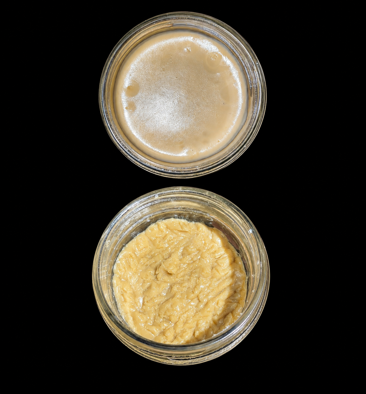 Two glass jars of solventless rosin shown from above, one smooth cold cure and one whipped badder texture